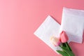 Sanitary pad, Sanitary napkin with tulip flower on pink background. Menstruation, Feminine hygiene, top view Royalty Free Stock Photo