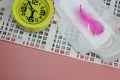 Sanitary pad, pen, calendar, clock on pink. Personal hygiene, the concept of feminine hygiene. Critical days, blood period,