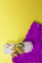 A sanitary pad tied with ribbon and female panties on the yellow background. Medicine, women health and ovulation concept. Copy