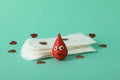 Sanitary pads, decorative blood drop and small hearts on mint background