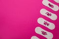 Sanitary pads with sequins on pink background, flat lay and space for text. Menstrual cycle Royalty Free Stock Photo