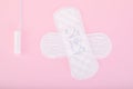 Sanitary pads and a tampon on a pink background Royalty Free Stock Photo