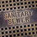 Sanitary Sewer Man Hole Cover Iron Lid Grungey Letters Royalty Free Stock Photo