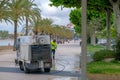 Sanitation service worker washes and cleans the streets