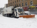 Sanitation truck shoves snow off Bronx street in NY