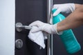 Sanitation worker disinfecting the door handle for covid-19 prevention Royalty Free Stock Photo