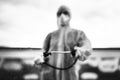 Sanitation worker in hazmat protection suit and N95 mask with chemical decontamination sprayer tank.Disinfecting streets and