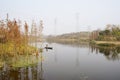 Sanitation worker paddling boat along river in sunny winter afternoon