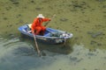 Sanitation workers clean up the rubbish in the river