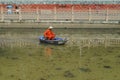 Sanitation workers clean up the rubbish in the river