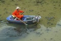 Sanitation workers clean up the rubbish in the river