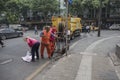 Sanitation workers cleaning up sewer debris