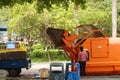 Sanitation workers loading and unloading garbage