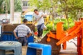 Sanitation workers loading and unloading garbage