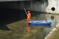 Sanitation workers in the river clean up garbage