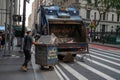 Sanitation workers with trash truck wheel bins in New York City Royalty Free Stock Photo