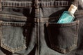 Sanitizer antiseptic gel in jeans pocket. take sanitizing bottle with you