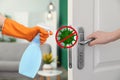 Sanitizing surfaces during coronavirus. Woman opening door, closeup