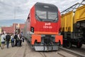 A group of teenagers inspect the new Russian electric locomotive 3ES8 \