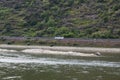 Sankt Goar, Germany - 08 04 2022: Reef in the Rhine and a bus on the road showing the sizes