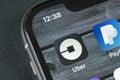 Uber application icon on Apple iPhone X screen close-up. Uber app icon. Uber is taxi car transportation application. Royalty Free Stock Photo