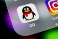 QQ messenger application icon on Apple iPhone X smartphone screen close-up. QQ messenger app icon. Social media network