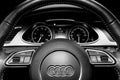 Close up of a Audi A4 S-line steering wheel. Modern car interior details. Speedometer, tachometer. Car dashboard. Black and white Royalty Free Stock Photo