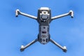 DJI Mavic 2 pro hovering over blue sky. DJI Mavic 2 Pro quadcopter or drone hovering in bright blue sky