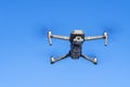 DJI Mavic 2 pro hovering over blue sky. DJI Mavic 2 Pro quadcopter or drone hovering in bright blue sky