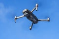 DJI Mavic 2 pro hovering over blue sky. DJI Mavic 2 Pro quadcopter or drone hovering in bright blue sky