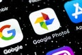 Google Photos application icon on Apple iPhone X screen close-up. Google Photos icon. Google photos application. Social media netw