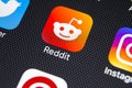 Reddit application icon on Apple iPhone X smartphone screen close-up. Reddit app icon. Reddit is an online social media network.