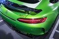 Green Mercedes-Benz AMG GTR 2018 V8 Bi-turbo exterior details. Back view. Car exterior details