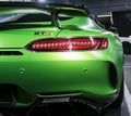 Green Mercedes-Benz AMG GTR 2018 V8 Bi-turbo exterior details, Headlight. Back view. Car exterior details