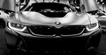 Luxury BMW i8 hybrid electric coupe. Plug-in hybrid sport car. Concept electric vehicle. Black and white. Car exterior details.