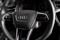 The new Audi A6 45TDI Quattro interior with steering wheel and digital dashboard. Modern car interior details