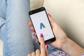 Google AdWords application icon on Apple iPhone X screen in woman hands. Google Ad Words Express icon. Google Adwords application