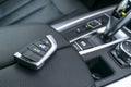 Close up of wireless keys of BMW X5 F15 2017 in black leather car interior. Modern Car interior details. Royalty Free Stock Photo