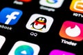 QQ messenger application icon on Apple iPhone X smartphone screen close-up. QQ messenger app icon. Social media network