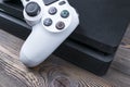 Sony PlayStation 4 Slim 1Tb revision and dualshock game controller. Game console with a joystick. Home video game console on wood Royalty Free Stock Photo