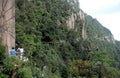 Sanqingshan Mountain in Jiangxi Province, China. People walking along a path clinging to the cliff high up on Mount Sanqing