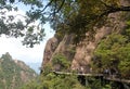 Sanqingshan Mountain in Jiangxi Province, China. People walking along a path clinging to the cliff on Mount Sanqing.