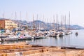 The view on Sanremo port full of sea boats, ships and yachts. Sanremo cityscape on the background