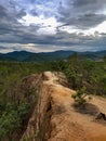 Sanstone path walk way down hill trees rain forest pai canyon dark sky sunshine light through clouds orange mountain Royalty Free Stock Photo