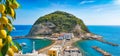 Sant`Angelo village, giant green rock in blue sea near Ischia Island, Italy Royalty Free Stock Photo