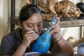 Sant Matin Ticajete, Mexico - 2019-11-26 - woman paints fine details on Alebrije wooden sculpture