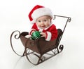 Santa baby sitting in a sleigh