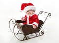 Santa baby sitting in a sleigh Royalty Free Stock Photo