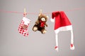 Santa bags, teddy bear and santa hat on a clothesline