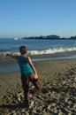 Santa Barbara Beach Performing Yoga Posture Of The Lord Of The Dance Nataraj. Nature Landscape Yoga.